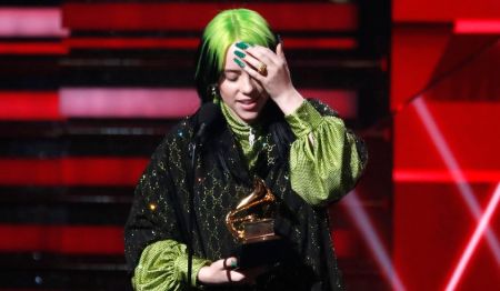 billie on the stage holding a grammy 